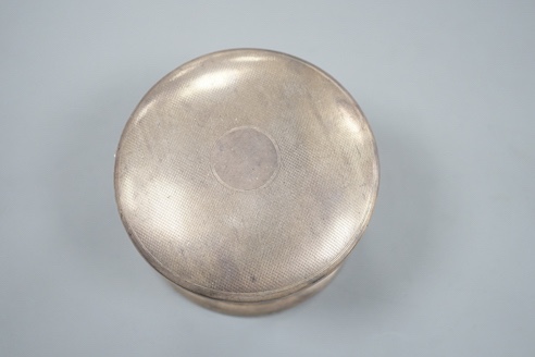 A George VI part engine turned silver circular powder box, A&J Zimmerman, Birmingham, 1937, 9cm.